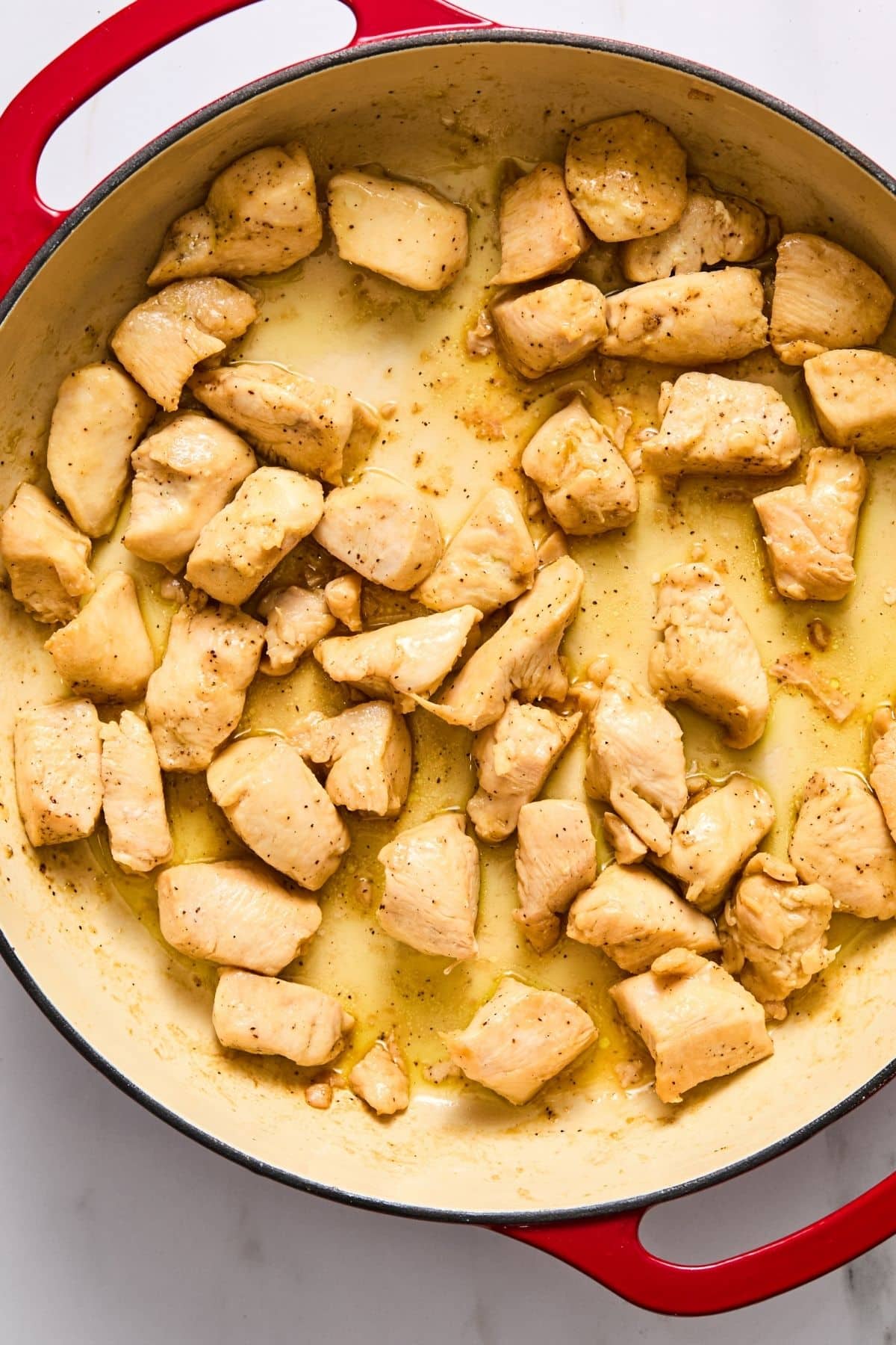 Chicken cooking in a skillet.