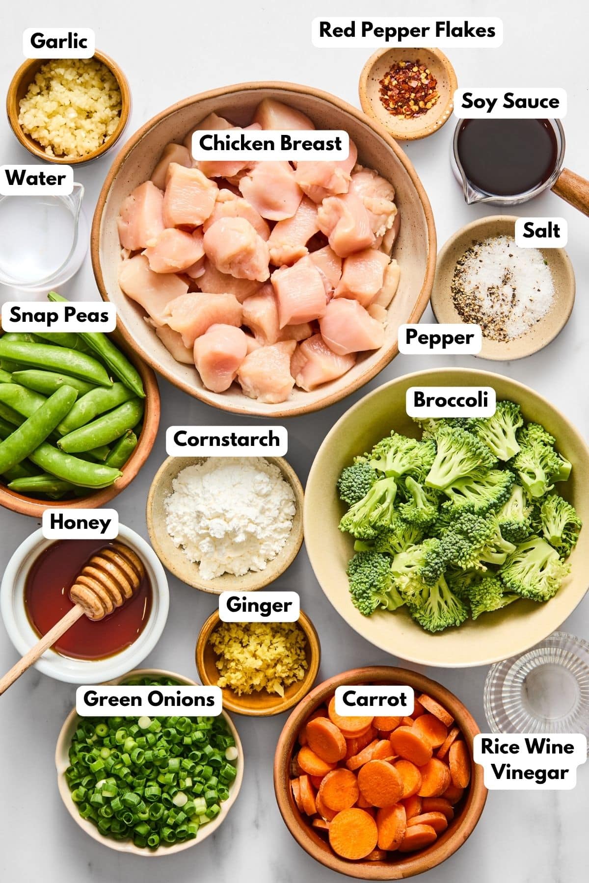 Ingredients to make this chicken teriyaki in bowls on a table.
