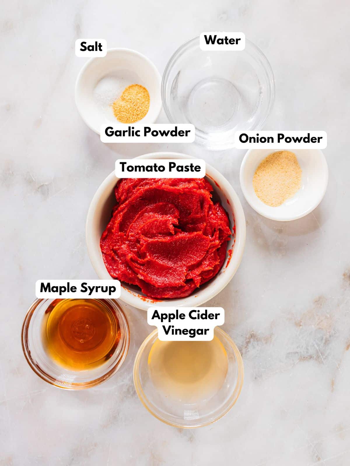 Ingredients to make this ketchup in bowls on a table.