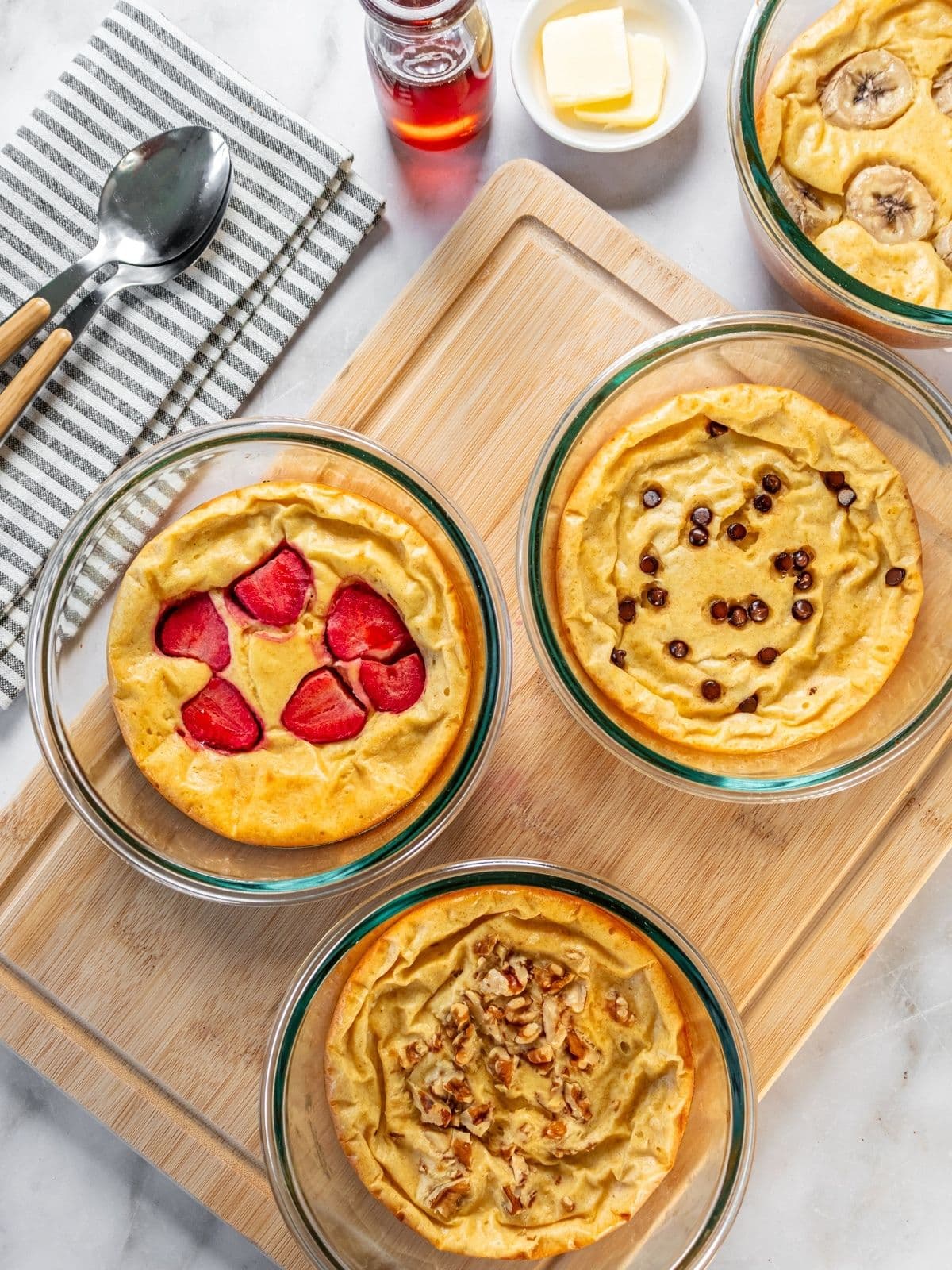 Protein pancake bowls resting on a cutting board.
