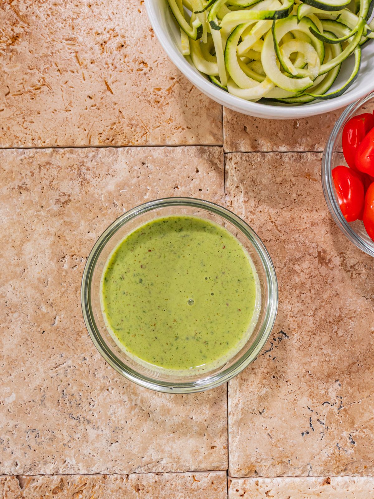 Ingredients for the pesto blended and put into a bowl.