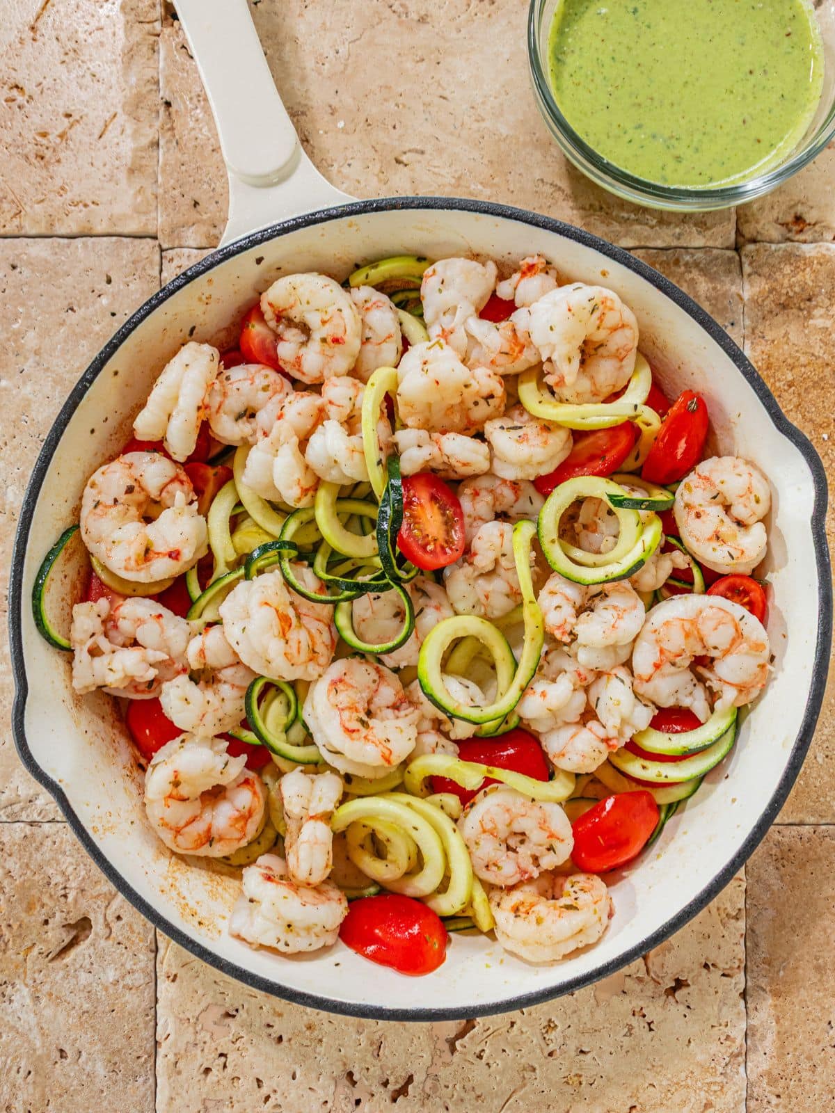 Tomatoes, zucchini, Italian seasoning, salt and pepper in a pan to cook.