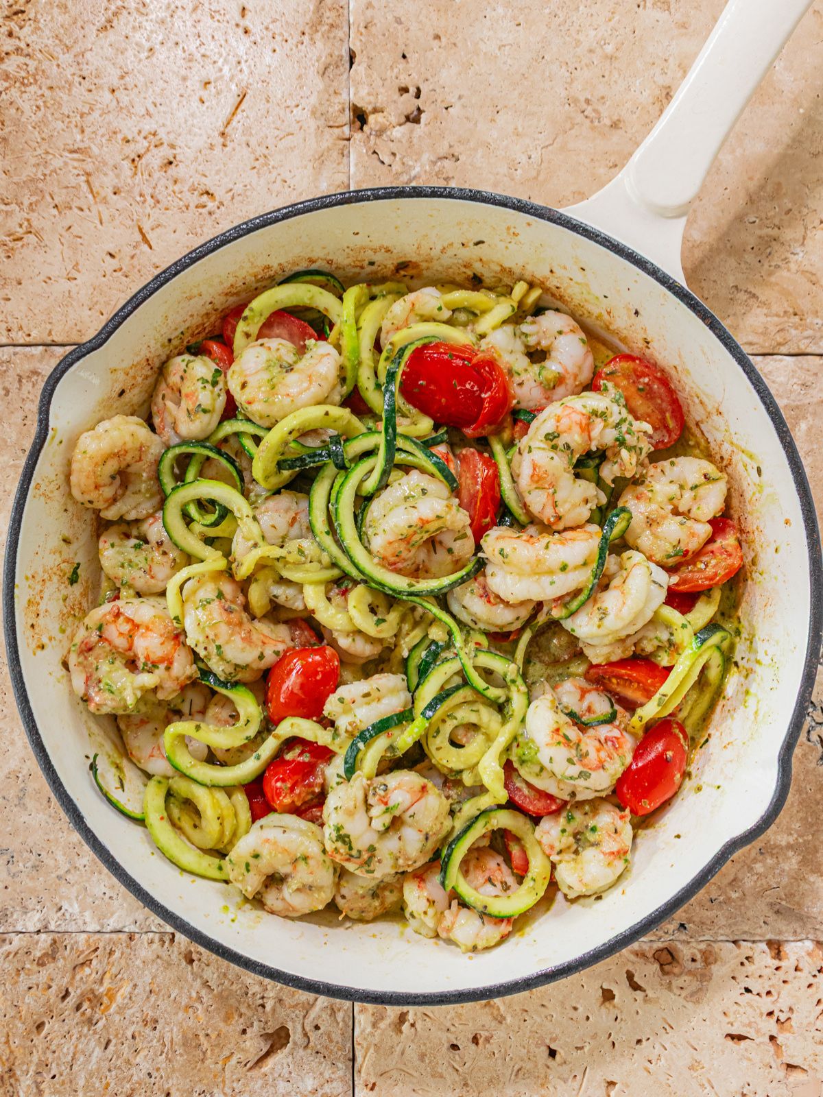 The pesto sauce tossed into the pan.