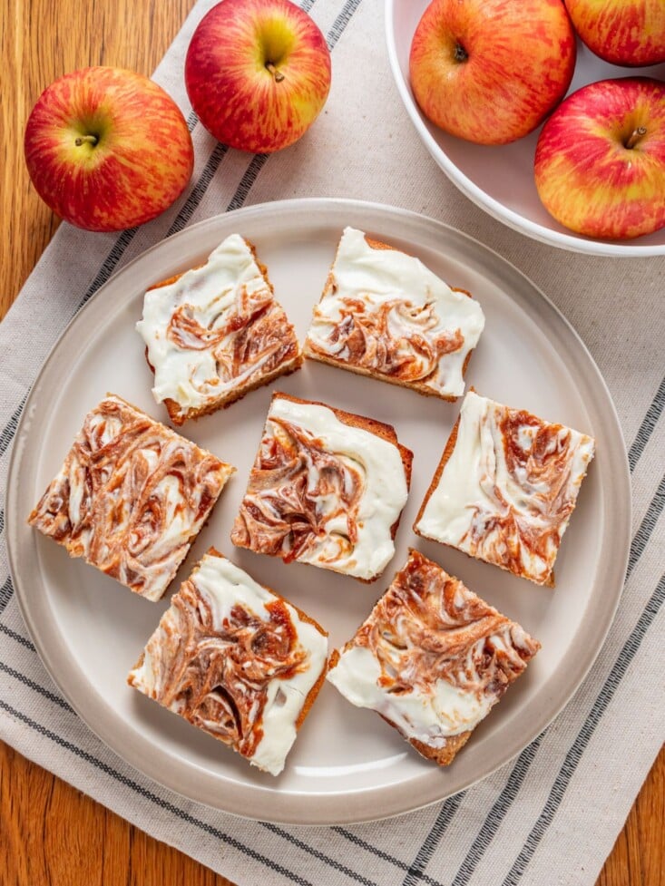 A plate filled with apple cream cheese bars cut up.