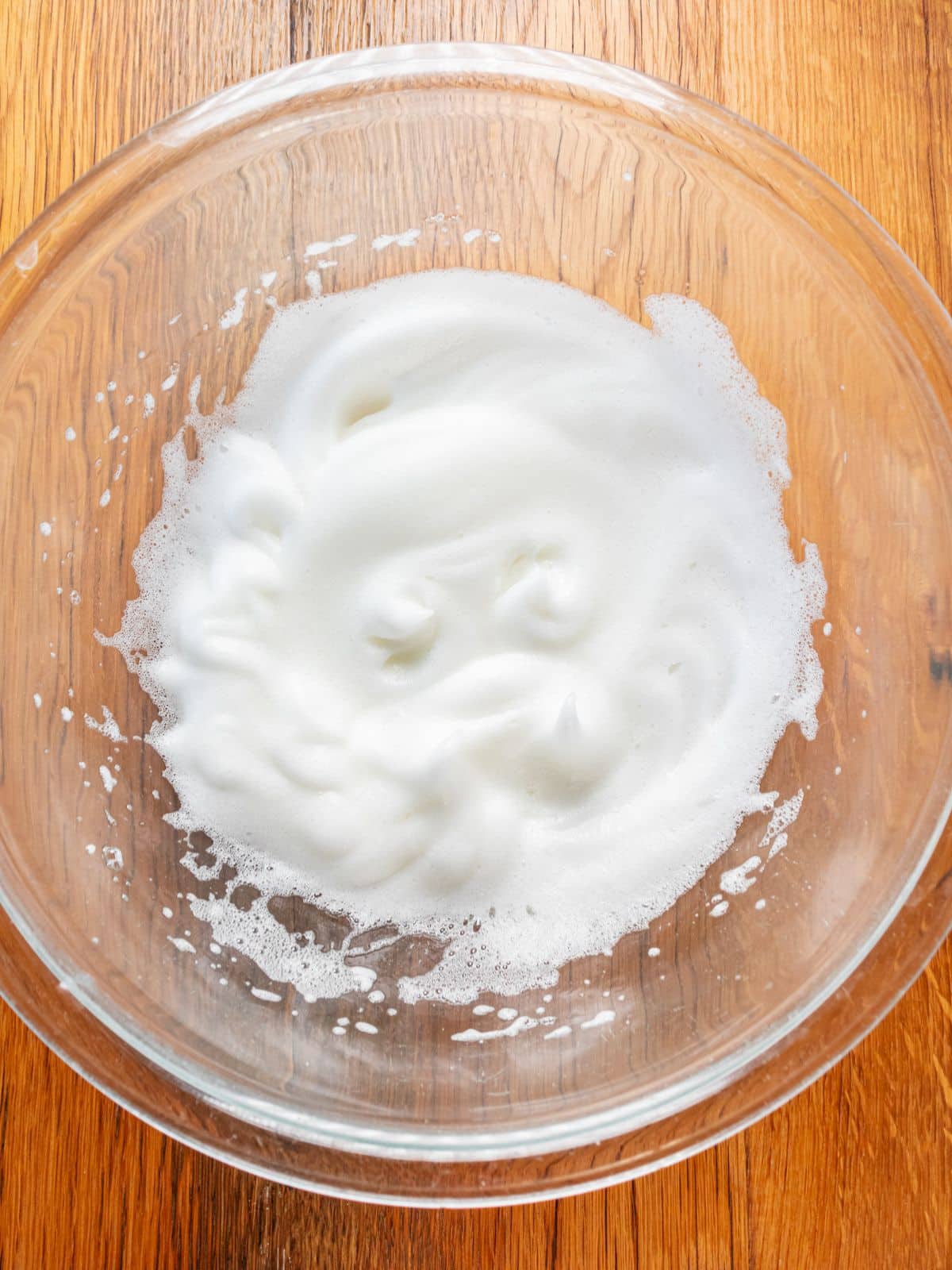 Egg whites whipped in a bowl.