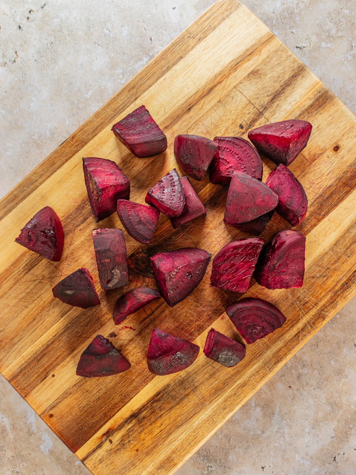 The beets cut up on a cutting board.