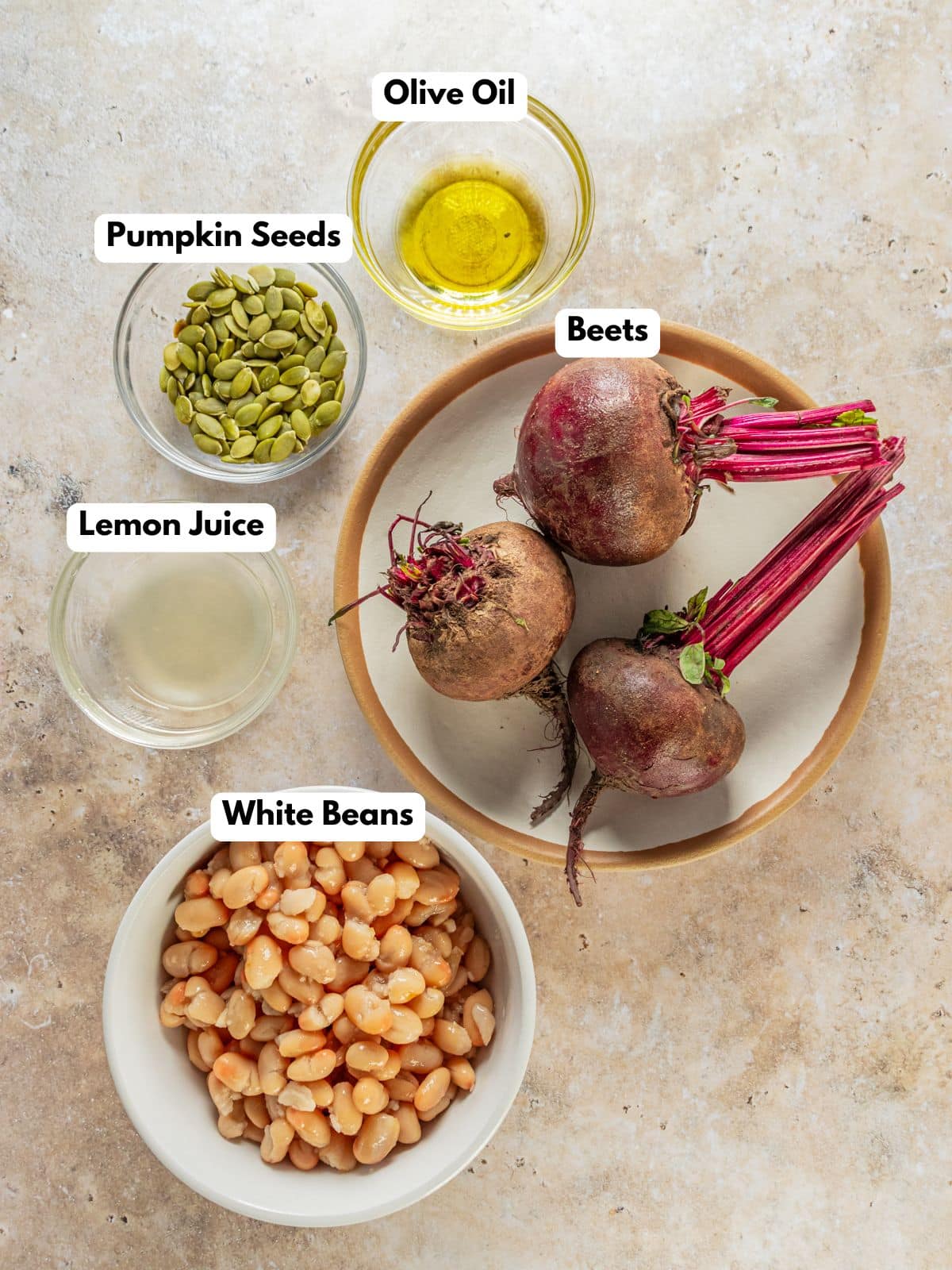 Ingredients to make this beet hummus in bowls on a table.