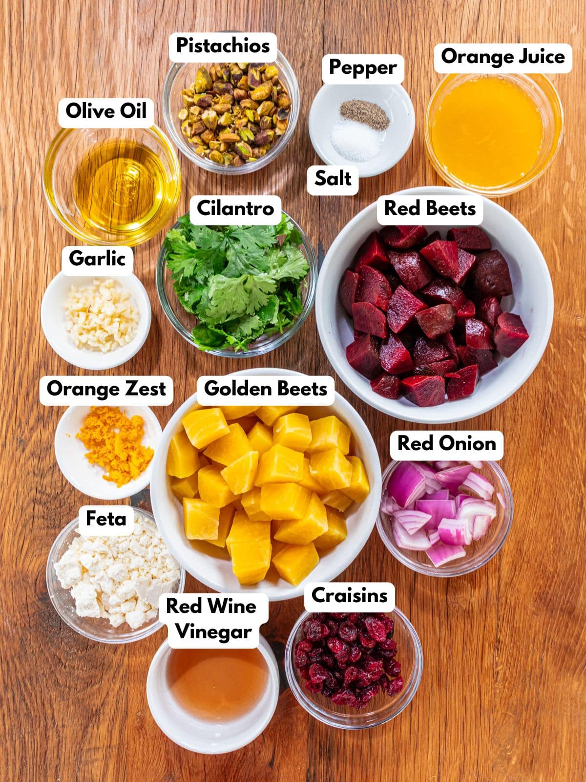 Ingredients to make this healthy beet salad in bowls on a table.