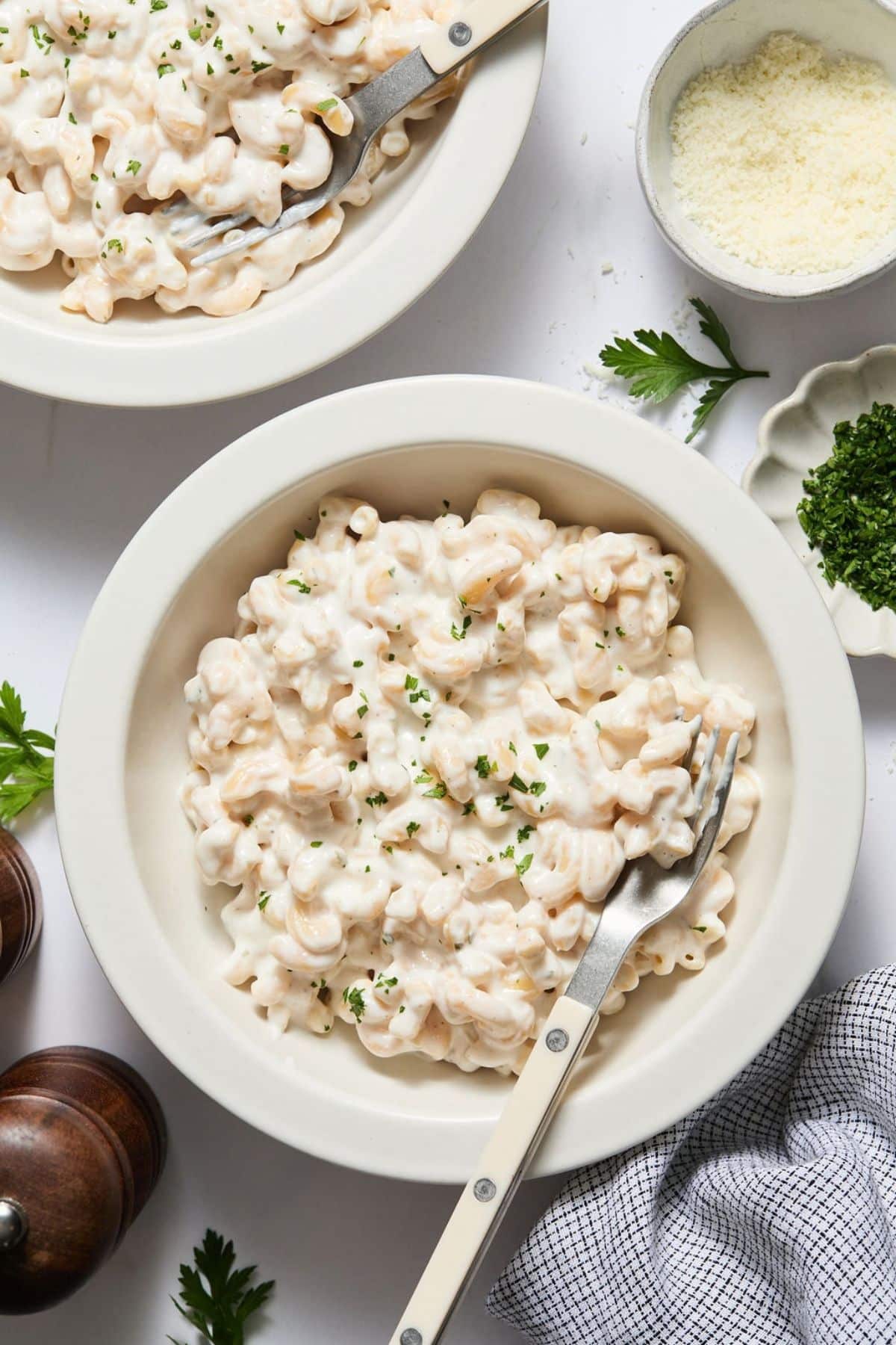 Cottage cheese alfredo sauce in a bowl over pasta with a fork resting in the dish.