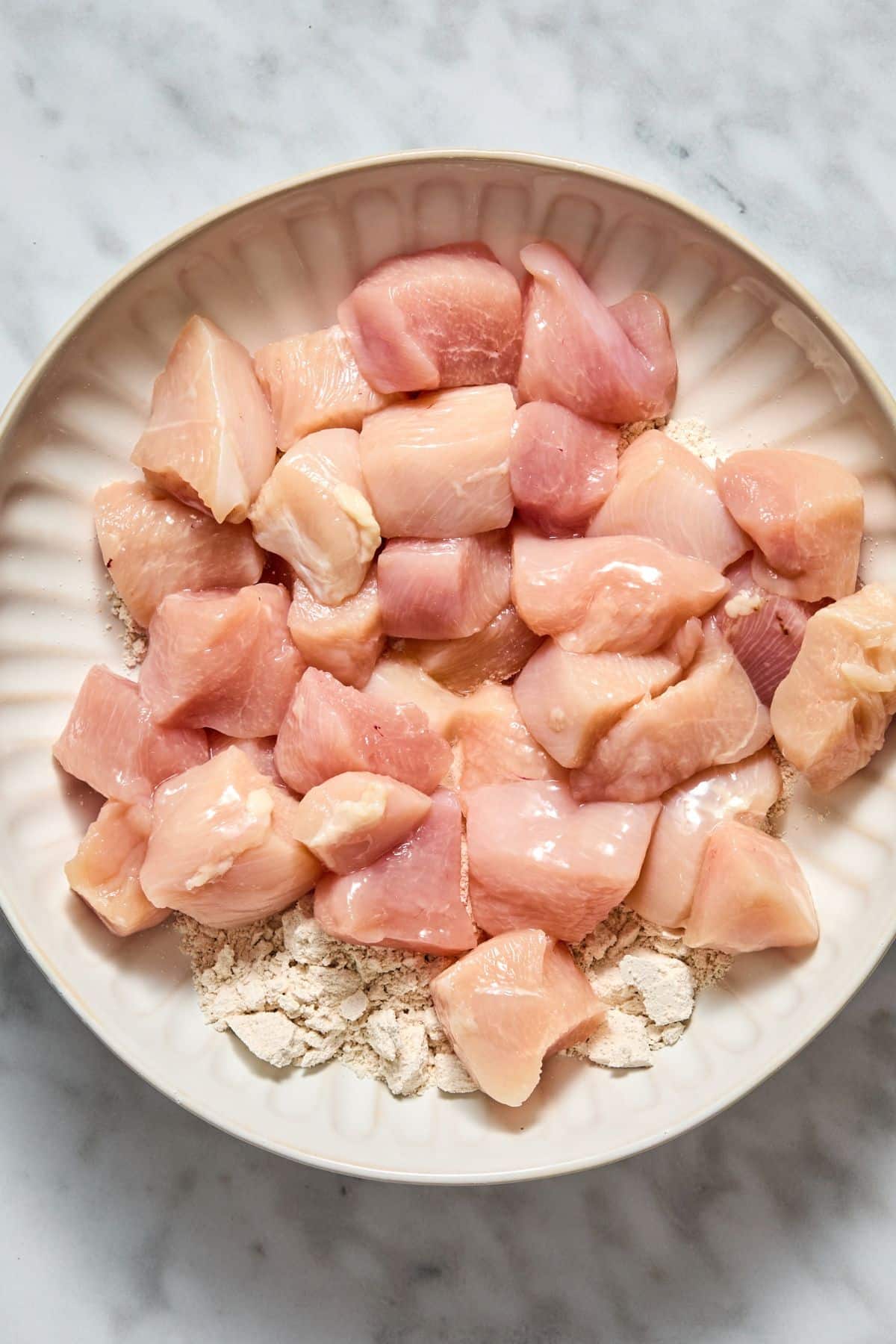 Raw chicken over flour.