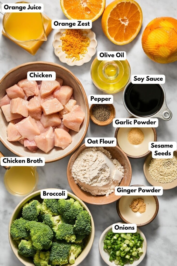 Ingredients to make this healthy orange chicken in bowls on a table.