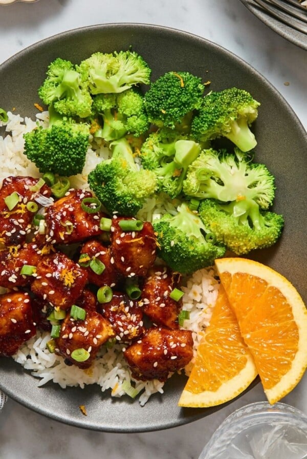 Healthy orange chicken with broccoli on the side.