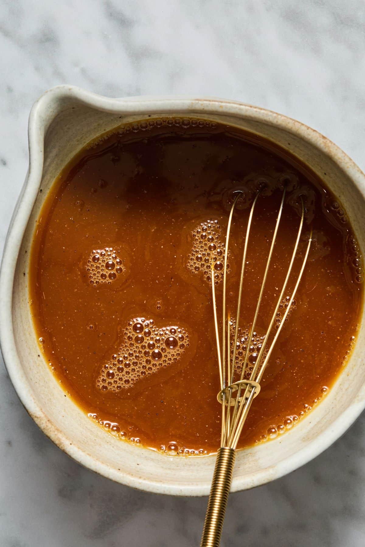 Orange juice, chicken broth, soy sauce, ginger powder, garlic powder, and pepper mixed together.