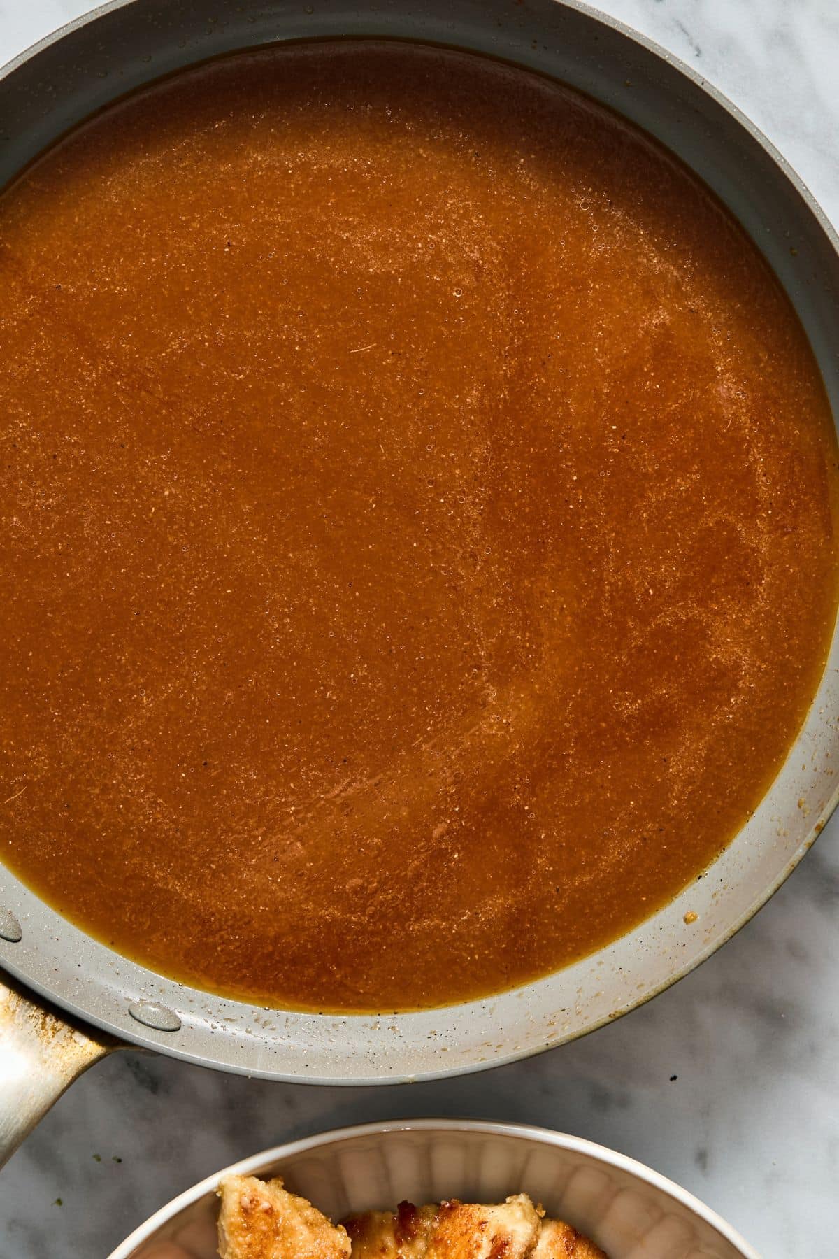 The sauce mixture cooking on the skillet.