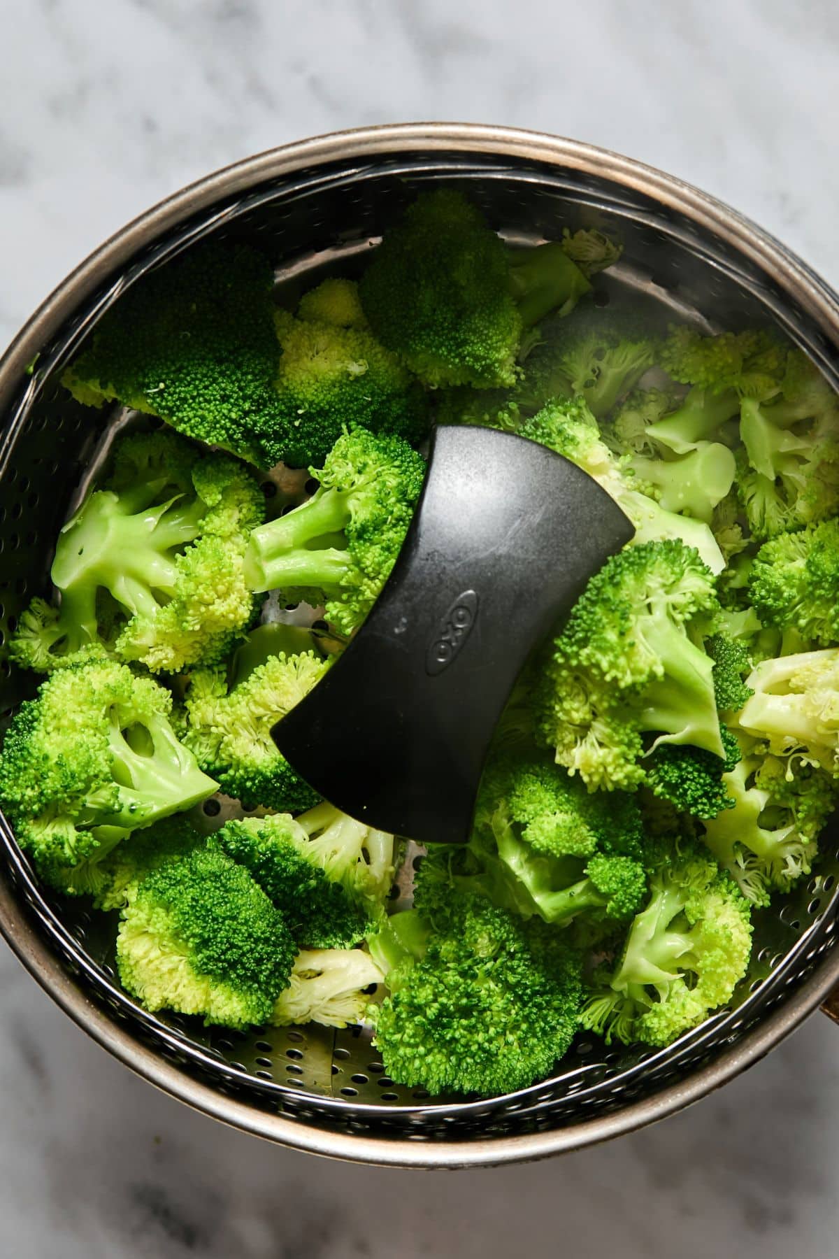 Broccoli steaming in a pot.
