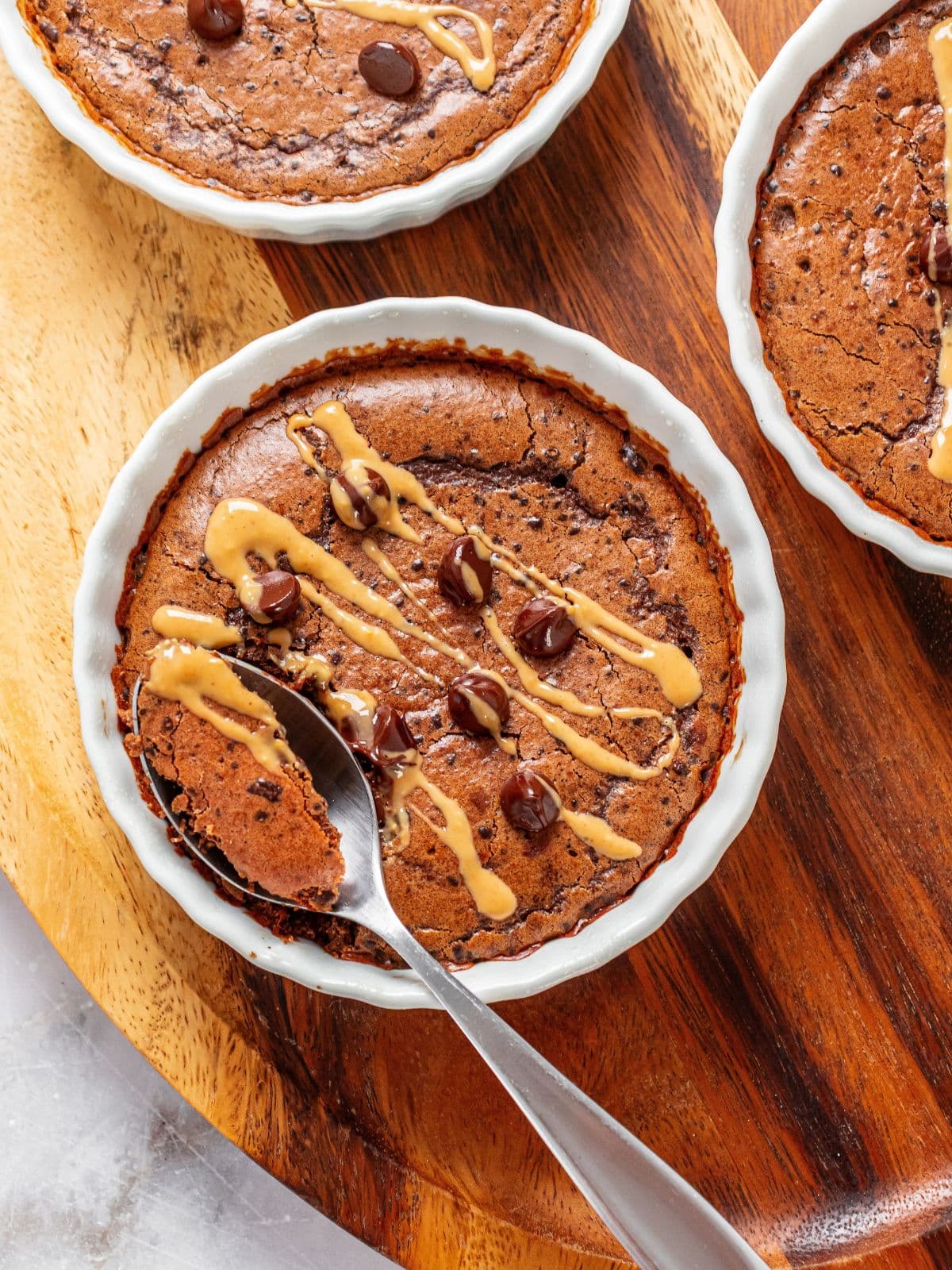 Protein mug cake in a ramekin with a spoon taking some out.