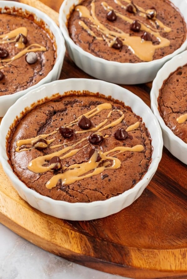 Four mug cake recipes on a cutting board.