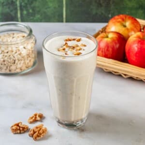 Apple smoothie with pecans on top.