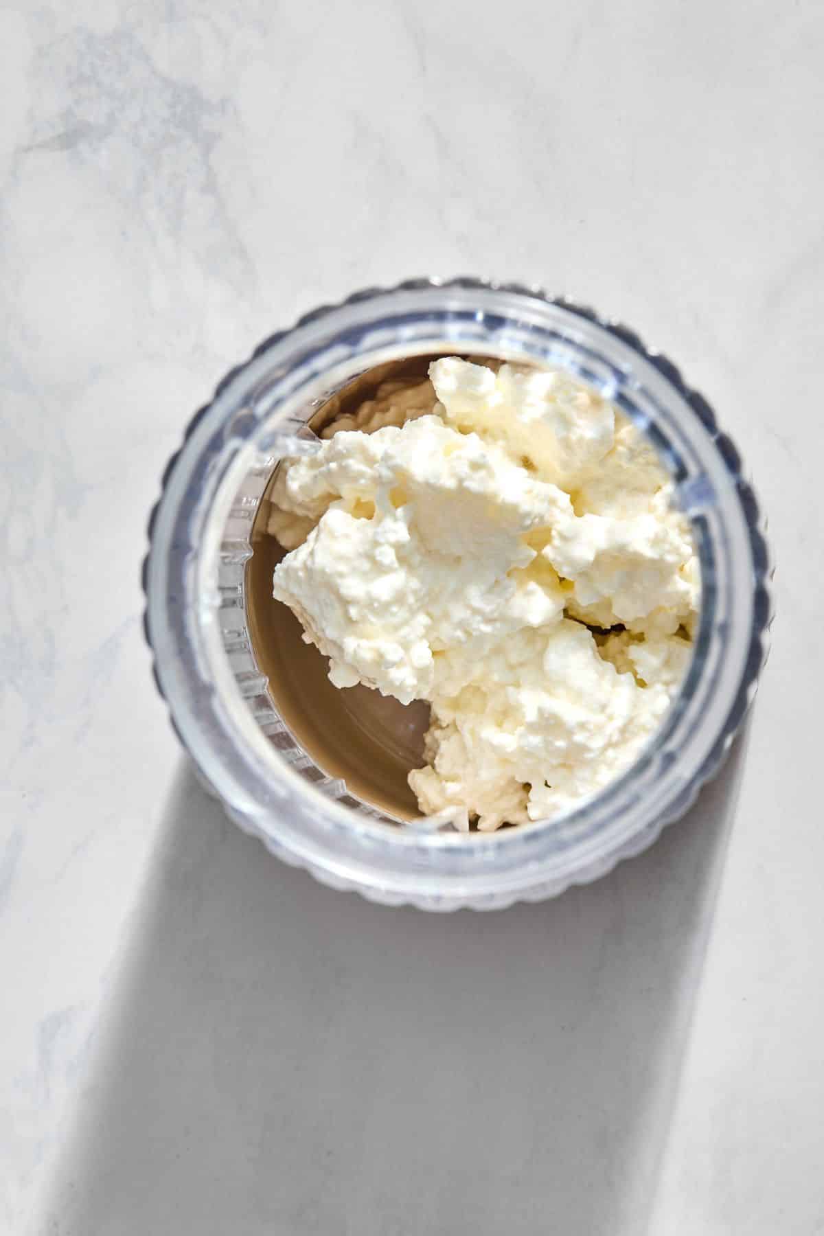 A blender filled with cottage cheese.