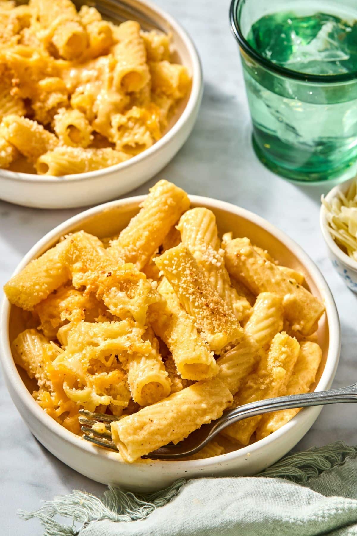 A bowl filled with mac and cheese with butternut squash inside.