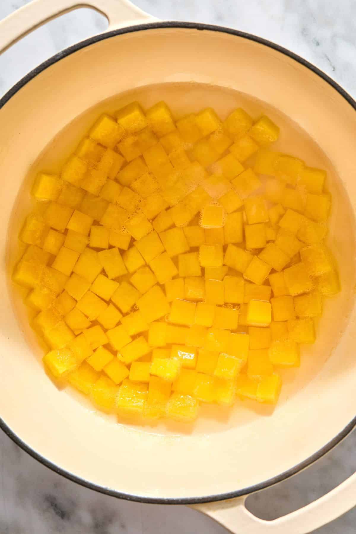 Butternut squash cooking in a pot.