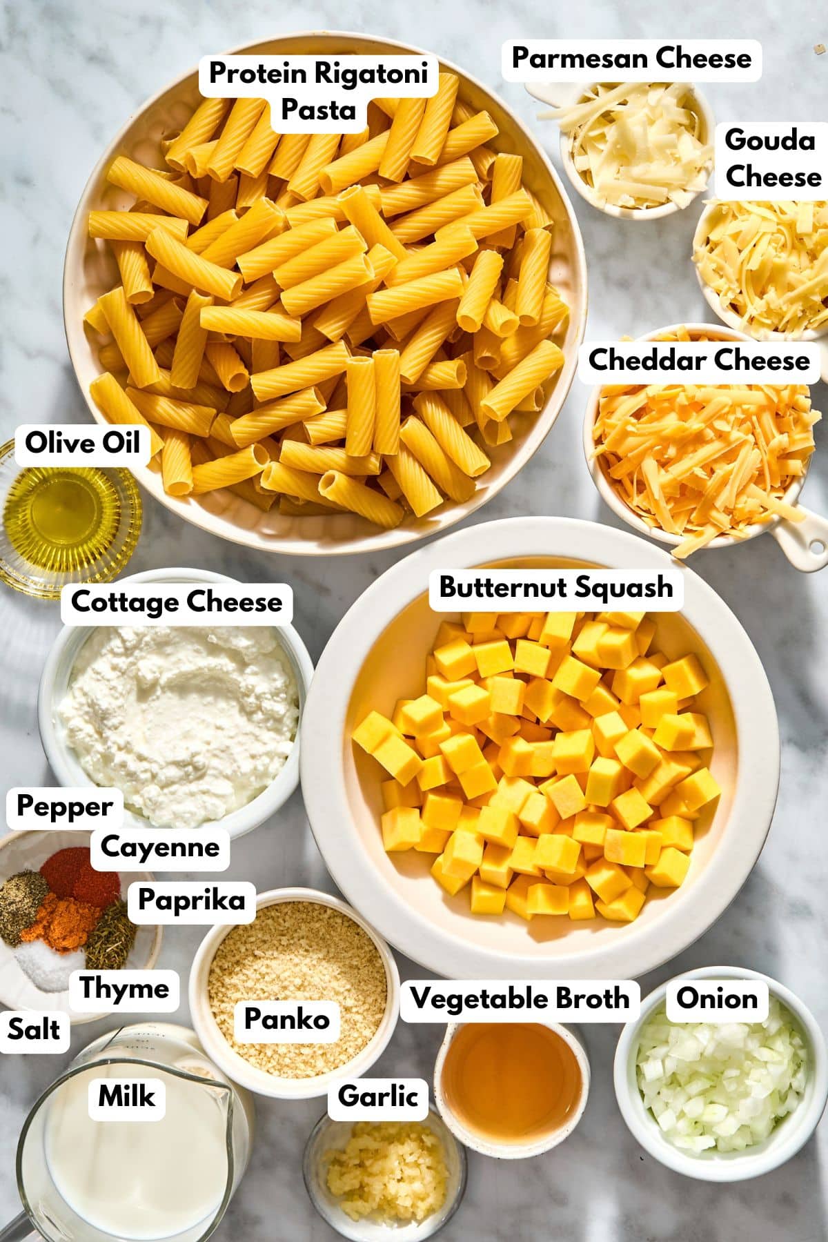 Ingredients to make this butternut mac and cheese in bowls on a table.