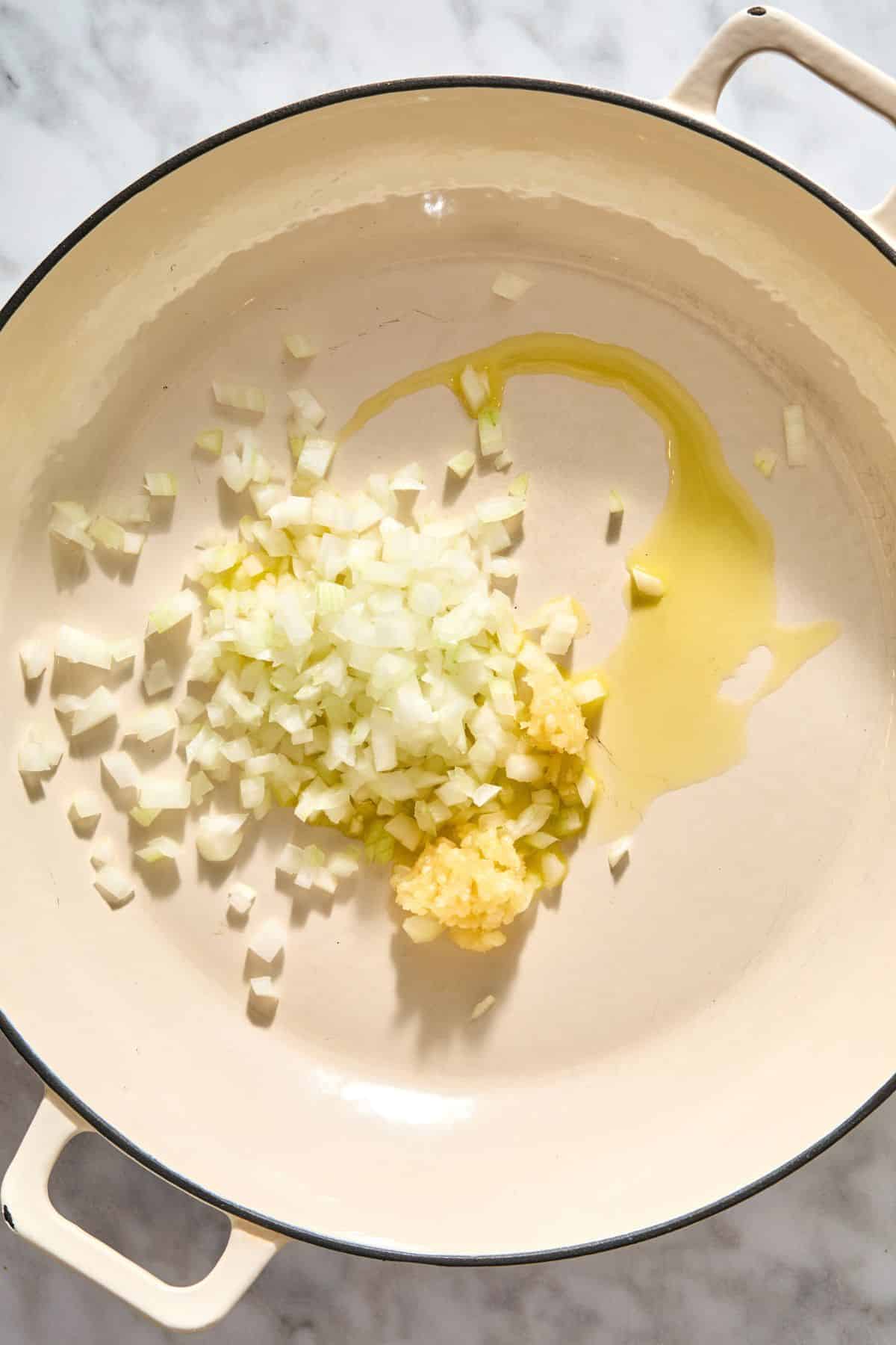 Cooking the onion and garlic in a pan.