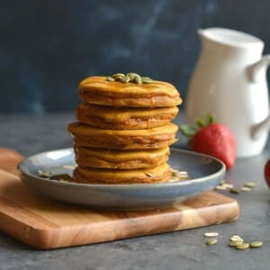 A plate stacked with butternut squash pancakes.
