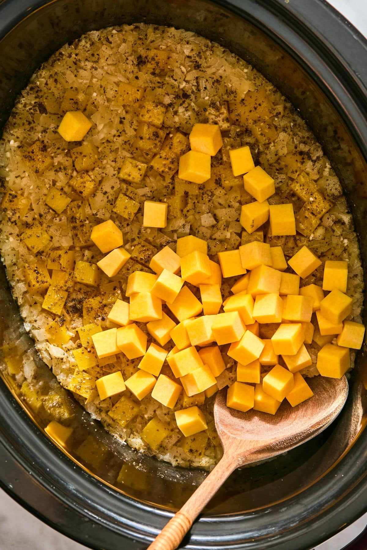 The remaining butternut squash added into the slow cooker.