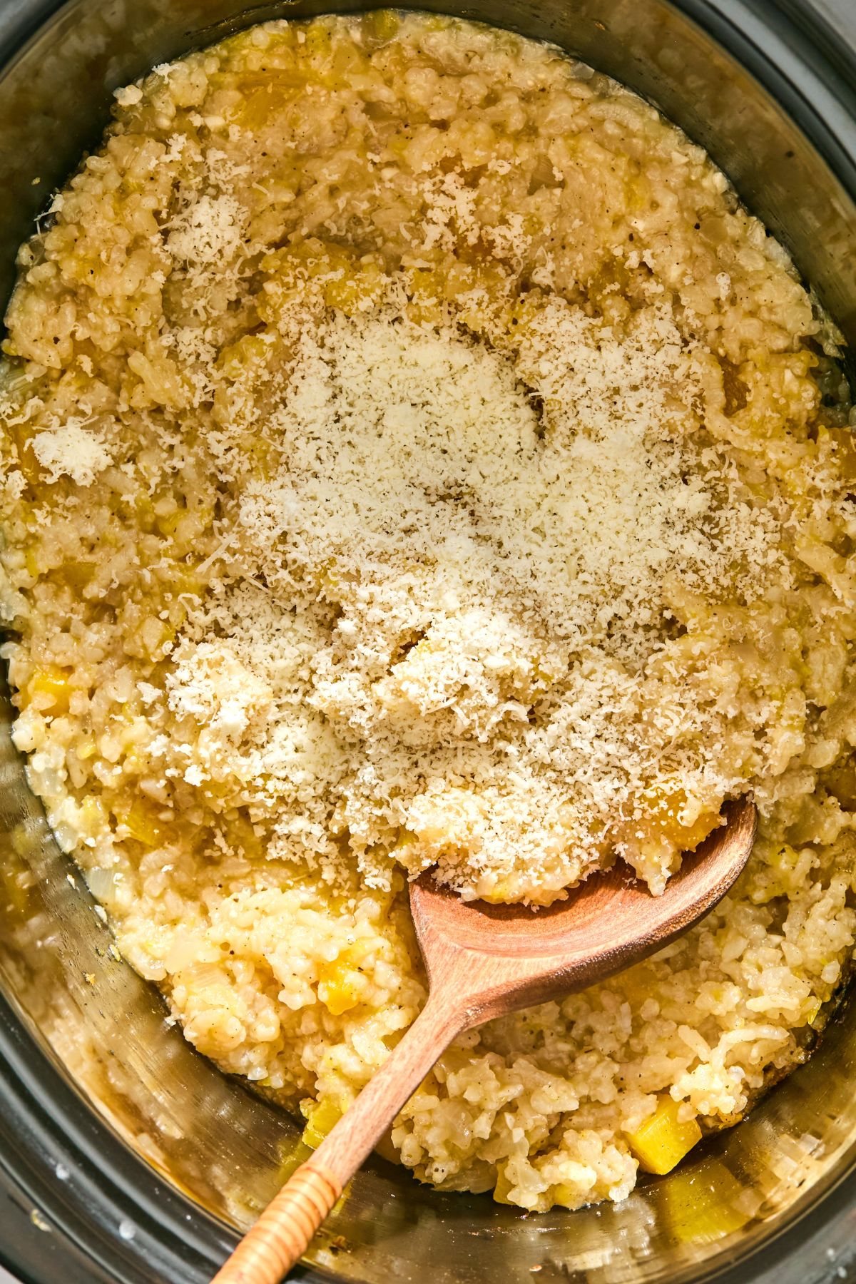 Parmesan cheese added to the slow cooker.
