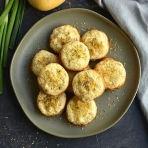 A plate filled with mashed potato muffins.